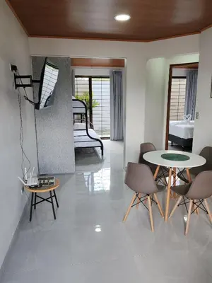 a living room with a table and chairs and a bed at Fortuna River Way Apartments in Fortuna