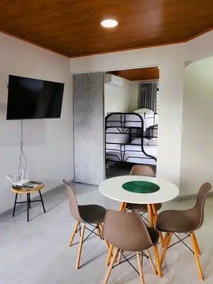 a living room with a table and chairs and a bed at Fortuna River Way Apartments in Fortuna