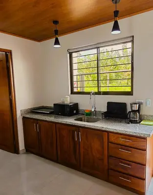 a kitchen with a counter with a sink and a window at Fortuna River Way Apartments in Fortuna