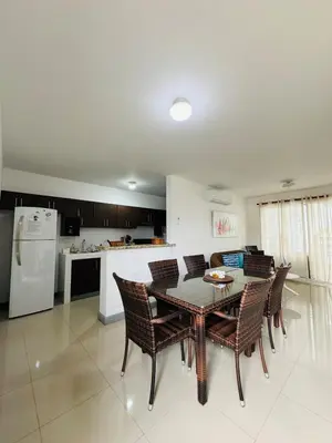 a kitchen and dining room with a table and chairs at Family home in Bejuco with pool and beach access in Bejuco