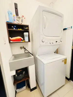 a kitchen with a sink and a washer and dryer at Family home in Bejuco with pool and beach access in Bejuco