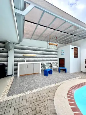 a patio with a pool and a table and chairs at Family home in Bejuco with pool and beach access in Bejuco