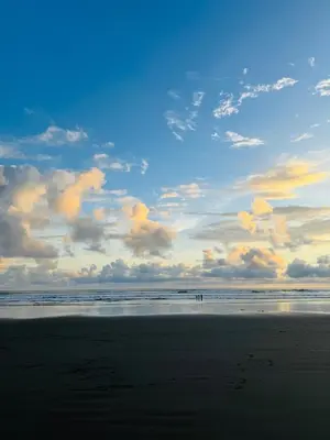 a beach with footprints in the sand and a cloudy sky at Family home in Bejuco with pool and beach access in Bejuco