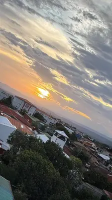 a view of a city with the sunset in the sky at Hotel Valladolid in Heredia
