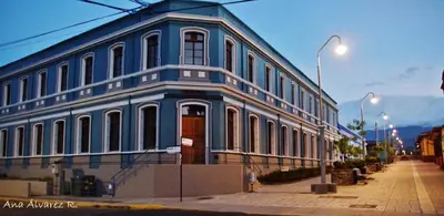 a blue building on the side of a street at Hotel Valladolid in Heredia