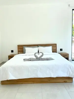 a white bed with a heart decoration on it at Casa McCash in Tamarindo