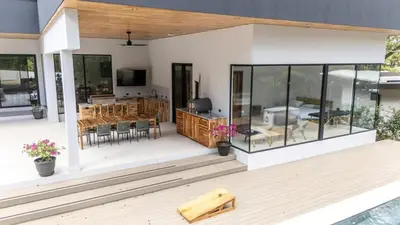 a house with a deck with a table and chairs at Casa McCash in Tamarindo