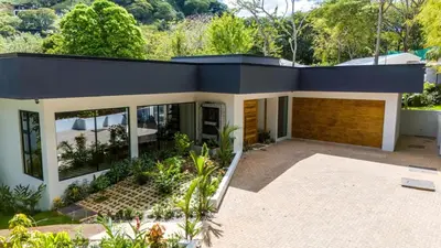 a house with a blue roof at Casa McCash in Tamarindo