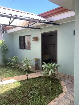 a pergola over a door of a house at Rincón Poeta in San Ramón