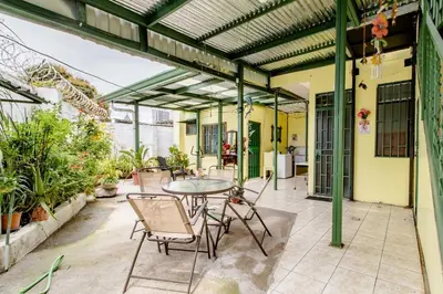 an outdoor patio with a table and chairs at Vilma Friendly Guesthouse - RB in San José