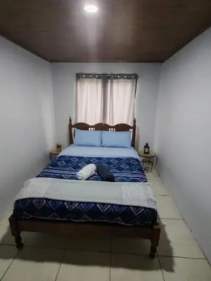 a bed with a person laying on it in a room at Alojamiento con lago privado en Bajos del Toro in Toro Amarillo