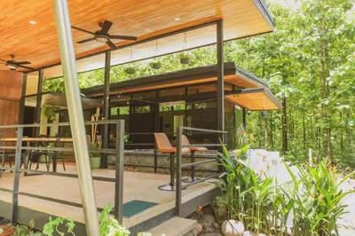 a house in the woods with a wooden roof at Avellanas Private Villa in Santa Cruz
