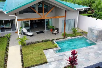 a house with a swimming pool in the yard at Calathea Arenal Villa in Agua Azul