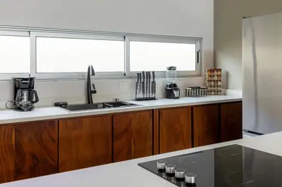 a kitchen with a sink and a window at Calathea Arenal Villa in Agua Azul