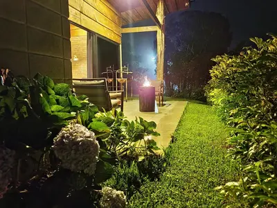a garden at night with a candle in the grass at Cabaña Moderna de Montaña en Zarcero con Vistas y Bosque Neblinoso in Zarcero