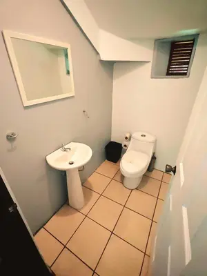 a bathroom with a sink and a toilet at Valle del Arenal House Family Home in La Fortuna in Fortuna