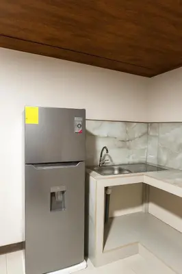 a kitchen with a stainless steel refrigerator and a sink at Fraijanes Mountain Stay in Alajuela City