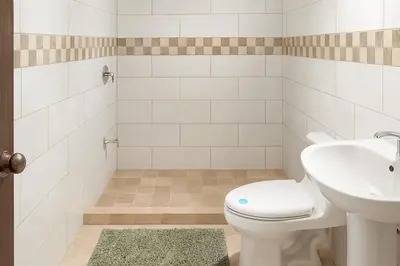 a bathroom with a toilet and a sink at Fraijanes Mountain Stay in Alajuela City