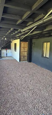 an empty building with a large room with a wooden door at Fraijanes Mountain Stay in Alajuela City