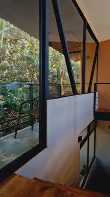 a room with a large window and a balcony at Tamara Monteverde View and Forest Chalet in Monteverde Costa Rica