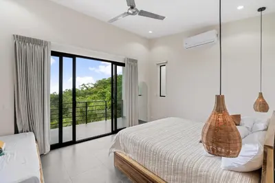 a bedroom with a bed and a balcony at Villas Vivo in Potrero