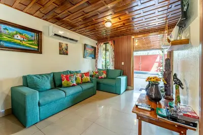 a living room with a blue couch and a table at Toucan River Paradise - River access, AC in Fortuna
