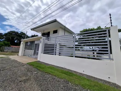 a white fence in front of a white house at Modern Home Near Playa Bandera Great Location in Parrita