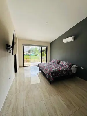 a large bedroom with a bed and a large window at Modern Home Near Playa Bandera Great Location in Parrita