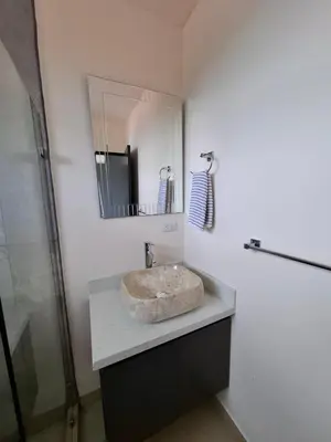 a bathroom with a sink and a mirror at Modern Home Near Playa Bandera Great Location in Parrita