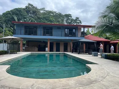 a house with a swimming pool in front of a building at Casa Lapa Herradura con piscina grande privada in Herradura