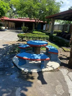 a picnic table with four blue seats in a park at Casa Lapa Herradura con piscina grande privada in Herradura