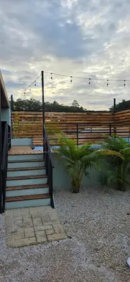 a set of stairs with a wooden fence and a fence at Live bambu in Caimital