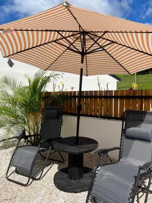 a table and chairs under an umbrella on a patio at Live bambu in Caimital