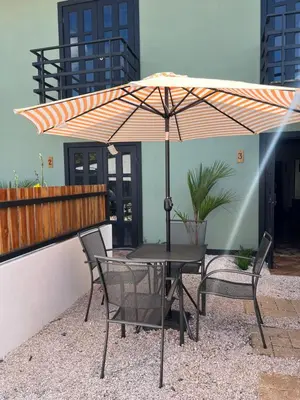a table and chairs under an umbrella on a patio at Live bambu in Caimital