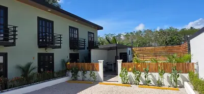 a house with a wooden fence in front of it at Live bambu in Caimital