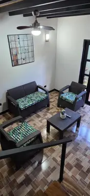 a living room with two couches and a table at Live bambu in Caimital