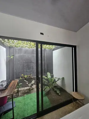 a room with a sliding glass door to a garden at Uvita Boutique Studios in Uvita