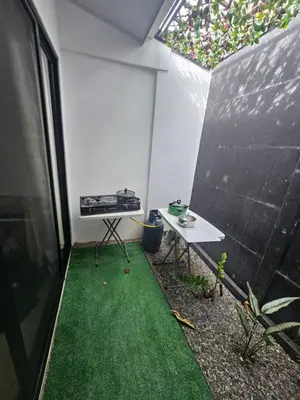 a small backyard with a table and a stove at Uvita Boutique Studios in Uvita