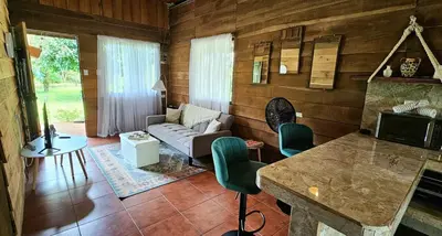 a living room with a couch and a table at Rustic House Private with Volcano View in Guayabal