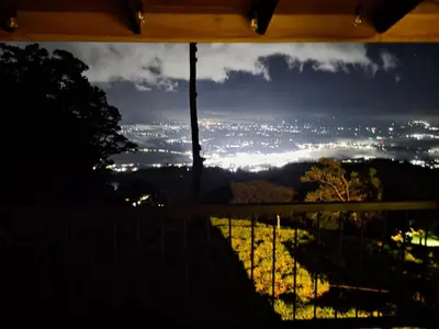 a view of a city at night from a window at San Vicente Mountain in Colón