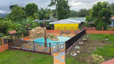a swimming pool in a yard with a fence at Rústicas Dani & Fam in Fortuna