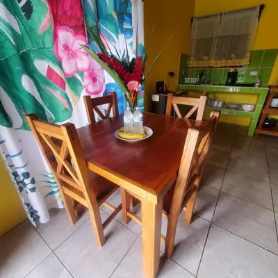 a wooden table with chairs and a vase with flowers at Rústicas Dani & Fam in Fortuna
