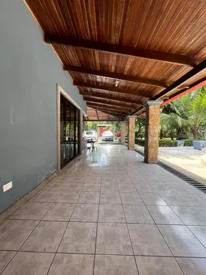 an empty patio with a wooden roof and a table at Casa Lapa Herradura Completa in Herradura