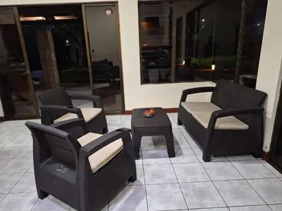 a group of chairs and a table on a patio at Casa Lapa Herradura Completa in Herradura