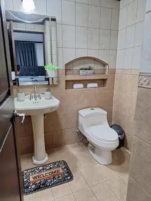 a bathroom with a toilet and a sink at Casa Lapa Herradura Completa in Herradura