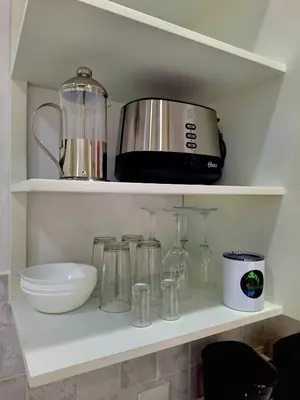 a kitchen shelf with a toaster and other kitchen items at Selvático Costa Rica in Chachagua