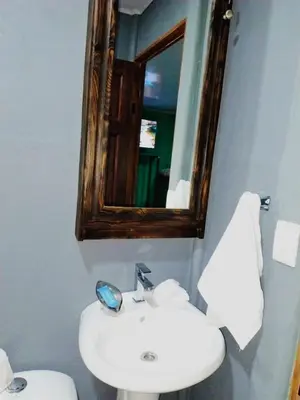 a bathroom with a sink and a mirror at La Fortuna Brisas del Recuerdo in Fortuna