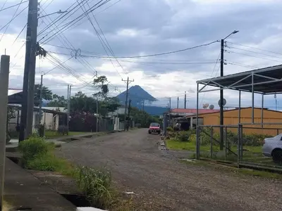 a street with a car parked on the side of a road at La Fortuna Brisas del Recuerdo in Fortuna