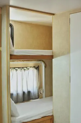 a bunk bed in a small room with a mirror at Tiny Soul in Santa Teresa Beach
