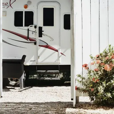 a white trailer parked next to a building at Tiny Soul in Santa Teresa Beach